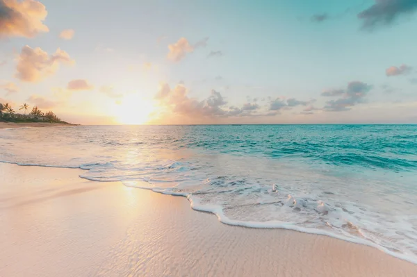 Turquoise sea washing onto a pale sandy beach